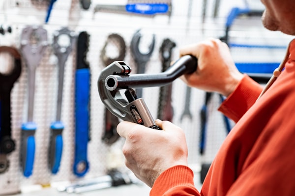 Professional tradesman with pipe wrench and plumbing tools